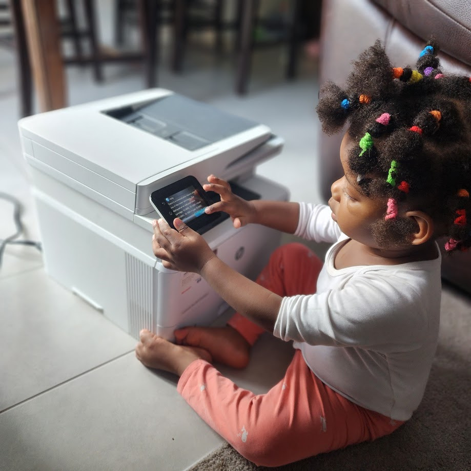 Child interacting with a printer touchscreen